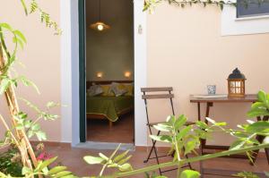 a bedroom with a bed and a table and a table at Twin House Spetses in Spetses