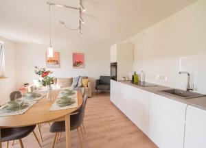 a kitchen and dining room with a wooden table in a room at Schön hier in Wehr