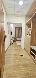 a hallway of an office with wooden floors and a couch at Modern & Comfy Studio-AlGhub 14 in Ras al Khaimah