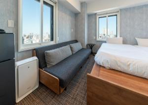 a hotel room with a bed and a couch at Tabist TOKYO CITY VIEW HOTEL in Tokyo +101 photos