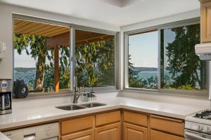 a kitchen with three windows and a kitchen sink at 3 Bed Gorgeous Views Hot Tub Dog Friendly Ada in Langley +111 photos