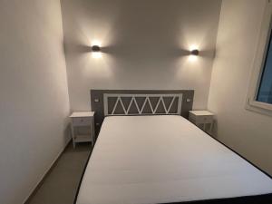 a bedroom with a bed and two night stands at Agriturismo Valle Del Chiarone in Pescia Romana