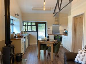 a kitchen with a wooden table and a kitchen with a stove at Sun Valley Retreat in Milton