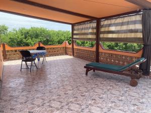 a screened in porch with a table and chairs at Casitas Las Palmas - Brisa Marina in Punta Mita +2 photos
