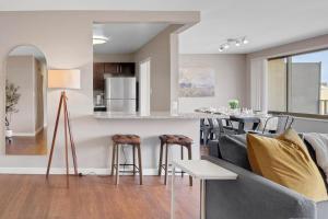 a kitchen and living room with a couch and a table at Boutique DCA Unit-Sleeps 7-Free Parking-Great Spot in Arlington