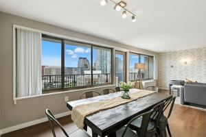a dining room with a table and chairs and windows at Boutique DCA Unit-Sleeps 7-Free Parking-Great Spot in Arlington