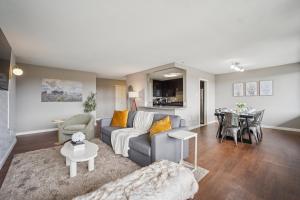 a living room with a couch and a table at Boutique Suite-Sleeps 7-Free Parking-Balcony Views in Arlington