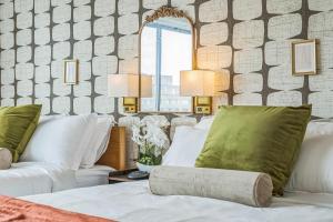 a bedroom with two white beds and a mirror at Boutique Suite-Sleeps 7-Free Parking-Balcony Views in Arlington +49 photos