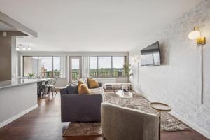 a living room with a couch and a table at Boutique Suite-Sleeps 7-Free Parking-Balcony Views in Arlington