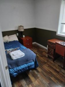 a bedroom with a bed and a dresser and a desk at Aurora Nights in Fairbanks +10 photos