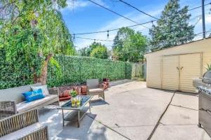 a patio with a couch and a glass table at Grosse Pointe Detroit 3BR - Sleeps 8 - Yard home in Grosse Pointe
