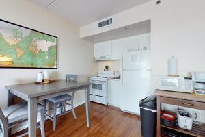 a small kitchen with a table and a refrigerator at Water Street Condos Unit 208 in Wilmington
