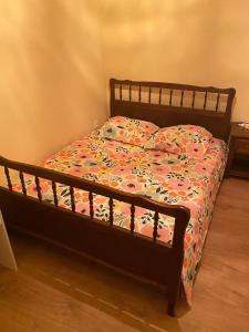 a bed with a comforter with flowers on it at Kronthal in Marlenheim