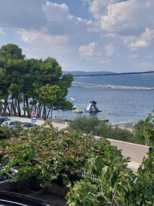 a view of a beach with a boat in the water at Apartman Silvija Čiovo in Slatine