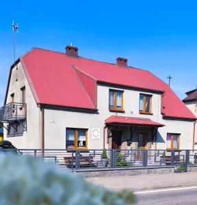 a large white building with a red roof at Apartamenty Wakacyjne WICJAN in Chałupy