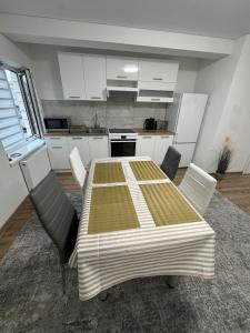 a kitchen with a table and chairs in a room at Florina namai in Marijampolė +17 photos