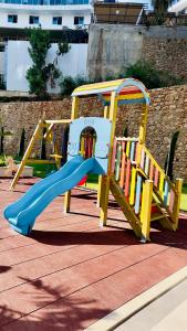 a playground with a blue and yellow slide at 2-х комнатная квартира в ЖК класса Luxe, Тосмур in Alanya