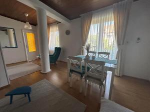 a living room with a table and chairs in a room at Apartment 086 in Cetinje