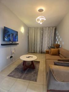 TV a/nebo společenská místnost v ubytování Residence next door 2br Coral