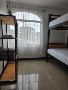 a room with two bunk beds and a window at Copey Inspira in El Copey