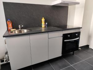 a kitchen counter with a sink and a sink at O'Couvent - Appartement 212 - 1 chambre - 63 m2 - Premier étage in Salins-les-Bains