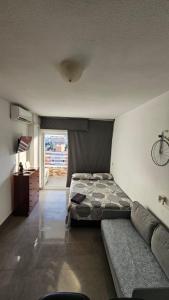 a bedroom with a bed and a couch at Nice studio with pool and internet fiber in Torremolinos