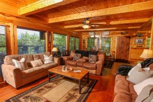 a living room with couches and a table at Glimpse of Bearadise in Gatlinburg