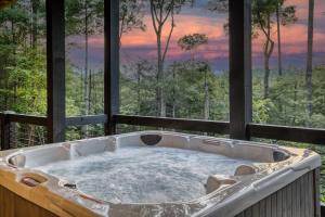 a jacuzzi tub on a balcony with a view at Morgan Trail - Stunning Mountain Masterpiece in Epworth