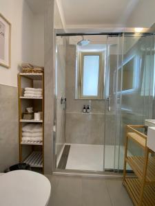 a bathroom with a shower with a glass door at HOMES By PALUMBO in Prunella +34 photos