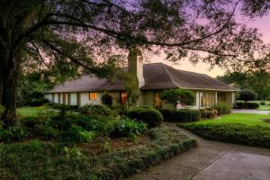 a house with a tree in front of it at The Howell House - Picturesque Countryside Retreat in Starkville