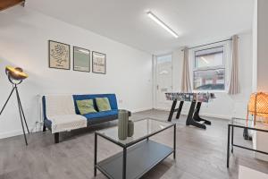 a living room with a blue couch and a table at The Sheriff's Den in Nottingham