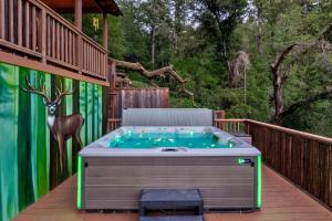 a hot tub on a deck with a mural at Skyview Grove Cabin in Camp Meeker