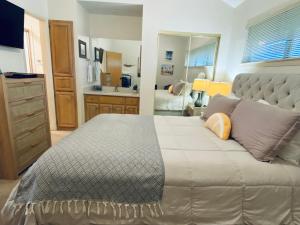 a large bedroom with a large bed and a bathroom at Condo de Comal CW C101 in New Braunfels