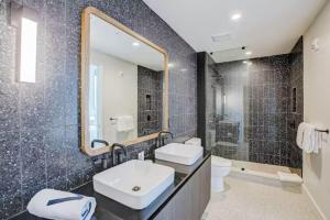 a bathroom with a sink and a mirror at Luxury Oasis - Stunning Condo Unbeatable Location in Austin +38 photos