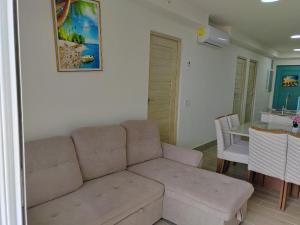 a living room with a couch and a table at Beautiful Beach in El Quindio