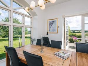 a dining room with a wooden table and chairs at 4 star holiday home in Hornsyld in Hornsyld