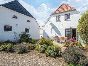 a white house with a patio in front of it at 4 star holiday home in Hornsyld in Hornsyld