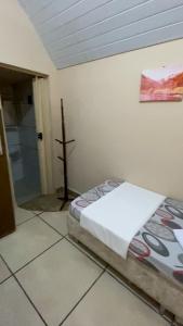 a bedroom with a bed and a cross on the wall at Parque Pousada Macaquinho Turismo in Serra Negra +145 photos