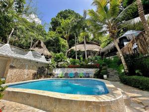 a swimming pool in a yard with a resort at Monte Verde Tayrona in El Zaino +106 photos