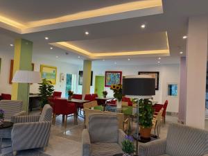a lobby with chairs and tables in a room at Hotel Dada Art Berlin 2-Bettzimmer in Berlin +8 photos