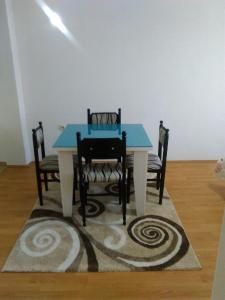 a dining room table with two chairs and a blue table at Apartman Strezoski in Ohrid