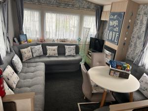 a living room with a couch and a table at CT12 The Beach Hut in Rhyl