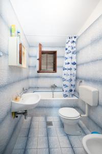 a bathroom with a toilet and a sink and a tub at Apartments and rooms with parking space Sukosan, Zadar - 24693 in Sukošan +21 photos