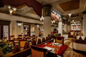 a restaurant with a long table and chairs at Gulf Hotel Bahrain Convention and SPA in Manama