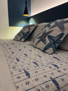 a bed with two pillows on top of it at Marea in Monopoli