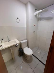 a small bathroom with a toilet and a sink at Ap em ótima localização in Cuiabá