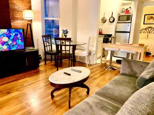 a living room with a couch and a table at PRIME LOCATION 2 BEDROOMS APT UPPER EAST SIDe in New York