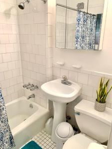 a bathroom with a sink and a toilet and a tub at PRIME LOCATION 2 BEDROOMS APT UPPER EAST SIDe in New York +19 photos