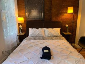 a bed with a backpack sitting on top of it at PRIME LOCATION 2 BEDROOMS APT UPPER EAST SIDe in New York