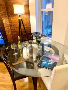 a glass table with a laptop on top of it at PRIME LOCATION 2 BEDROOMS APT UPPER EAST SIDe in New York